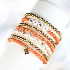 Do you want to give yourself or a loved one a lucky charm, then these bracelets are just right. The orange jade bracelet with the letter pendant and the gold-plated pearl bracelet are a noble combination and a real eye-catcher. You can wear the beautiful delicate bracelets individually or as a trendy combination. The stones are strung on a stretch band, so the bracelet is easy to slip over your hand. ❤ Handmade with love I High-quality I Lovely packaging ❤ DETAILS Mashan jade orange-gold colored (4 mm). Cultured pearls (6-7x5mm) Pendant brass 14k gold plated Brass beads 14k gold plated (does not ring) Elastic nylon strap ❤ Jade it is considered the stone of love and friendship and inner peace. PLEASE NOTE Since natural stone is used, each bead and bracelet is unique. ❤ You can find more pe Orange Round Beads Jewelry For Everyday, Everyday Orange Round Bead Jewelry, Trendy Round Beads Jewelry For Personalized Gift, Elegant Orange Bracelet For Gift, Personalized Letter Bead Bracelet Jewelry, Stackable Pearl Bracelet Gift, Gift Stackable Pearl Bracelet With Round Beads, Stackable Pearl Bead Bracelet As A Gift, Stackable Pearl Bracelet With Round Beads As Gift