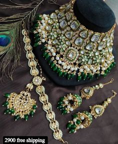 green and white jewelry set with peacock feathers