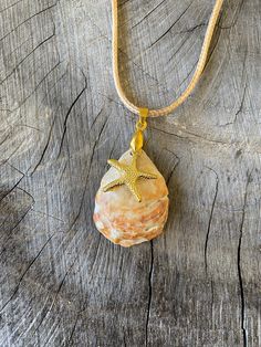 Handpicked shell from Nokomis Beach, Florida.  Gold starfish charm and necklace. I walk my local beach almost every morning in SW Florida.  I collect all kinds of shells, rocks, fossils and teeth.  Since I can't stop collecting, I decided to start making jewelry and crafts out of my beloved beach treasures.  Everything in my shop was happily hand-picked and hand-crafted by me :)  5% of all my Etsy sales go to Mote Marine in Sarasota Florida, specifically to help fund Turtle Patrol, they mark and Ocean-inspired Starfish Charm Necklace For Vacation, Vacation Ocean-inspired Starfish Charm Necklace, Starfish Charm Necklace For Beach Season Vacation, Starfish Charm Necklace For Beach Vacation, Beach Season Starfish Charm Necklace For Vacation, Handmade Shell Charm Necklace For Beach, Gold Starfish Charm Necklace For Beach Season, Beach Season Vacation Necklace With Starfish Charm, Handmade Shell Charm Necklaces For Beach