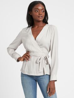 SOFT & SMOOTH: Made with our fluid twill fabric, which has a subtle shine and is easy to care for.  WRAP-EFFECT: An attached belt wraps around the waist to create a wrap-effect.  Low v-neck.  Decorative topstitch detail.  Straight hem.  Unlined.  Semi-fitted.  Long sleeves.  Hip length.  Body length (size S): Petite 25. 5", Regular 26. 5", Tall 28" Sleeve length: Petite 30", Regular 31. 5", Tall 33. 5" Model: Size XS, 5'10" (178cm) Stitch Fix 2020, Current Styles, Peplum Blouse, Neck Wrap, Wrap Blouse, Plus Size Swimwear, Twill Fabric, Body Shape, Petite Size