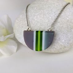 One of a kind handmade fused glass pendant. Simple and elegant modern minimalist style Transparent green gray and with stripes with geometric shape. Size: 30mm x 20mm x 6mm. Cast silver necklace attachments. Incorporates Bullseye opal and transparent glass. Sculpted by hand and fused multiple times. Includes nickle free hypoallergenic 18 inch attached chain. Message anytime with questions. -Sean Modern Green Round Pendant Jewelry, Modern Green Geometric Jewelry, Minimalist Green Glass Jewelry, Modern Green Necklace As Gift, Modern Green Necklace For Gift, Modern Green Necklace As A Gift, Geometric Green Jewelry Gift, Green Geometric Jewelry Gift, Green Geometric Jewelry For Gifts