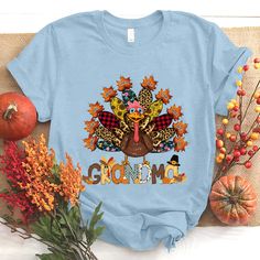 a blue t - shirt with an image of a turkey and the word mom on it