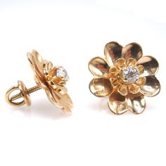 "These charming vintage earrings, in the shape of a daisy, are made of 14K yellow gold and have a diamond prong set in their center. Perfect for \"setting and forgetting,\" these earrings are secured with a screw back, meaning you'll never have to worry about one of them falling out! DETAILS METAL: 14K Yellow Gold DIAMONDS: 2x European Cut diamonds (0.40tcw) WIDTH: 17mm" Wedding Flower Earrings In 14k Yellow Gold, 14k Yellow Gold Flower Earrings For Anniversary, Formal Flower Shaped Diamond Earrings In 14k Gold, Formal 14k Gold Diamond Earrings With Flower Shape, Formal 14k Gold Flower-shaped Diamond Earrings, Formal 14k Gold Diamond Earrings In Flower Shape, Classic Gold Diamond Flower-shaped Earrings, Classic 14k Gold Flower-shaped Earrings, Classic Diamond Cluster Earrings With Flower Shape