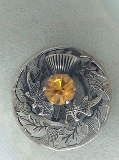 "A antique Scottish Thistle Pin with Carnigorn Center. Measures 1\" long by 1\" wide approximately. Gift box with purchase, ready for gift giving. Great gift for friend gift or a gift for her." Victorian Engraved Brooches As Gift, Heirloom Engraved Brooches For Gifts, Unique Engraved Brooches As Gifts, Unique Engraved Brooches For Gift, Antique Engraved Brooch As Gift, Victorian Style Round Brooches For Gifts, Classic Brooch Pins As Gift, Antique Silver Vintage Brooches As Gift, Heirloom Round Brooches As Gifts