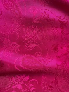 a pink fabric with an intricate design on it's side and the background is very soft