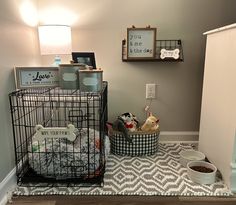 a cage with some stuffed animals in it on the floor next to a lamp and pictures