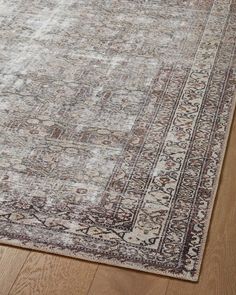 an area rug on the floor with wooden floors