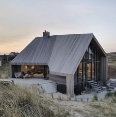 the house is made out of wood and has a pitched roof