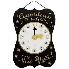 a black and gold clock with the words new year written on it's face