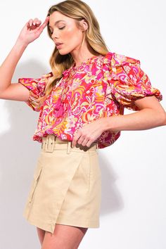 A printed woven top featuring ruffled neckline with tie/tassel and puff sleeve with ruffle over shoulder Details: Self : 85% RayonLining: 15% Nylon Size & Fit - Model is 5`8" And Wearing Size Small- Measurements Taken From Size Small- Approx. Length: 23 3/4" Printed Blouse With Ruffle Sleeves, Spring Multicolor Puff Sleeve Top, Summer Tops With Balloon Sleeve And Ruffle Hem, Multicolor Balloon Sleeve Puff Top For Summer, Multicolor Blouse With Gathered Sleeves, Summer Balloon Sleeve Tops With Ruffle Hem, Trendy Printed Blouse With Ruffle Sleeves, Multicolor Puff Sleeve Top With Gathered Sleeves, Multicolor Tops With Gathered Sleeves For Spring