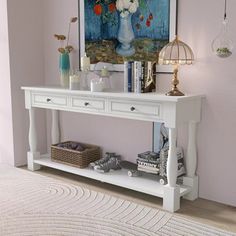 a white console table with flowers on it