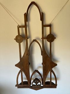 an old clock hanging on the wall with two pendulums attached to it's sides