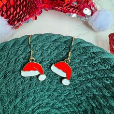 These cute little Santa Hat earrings are sure to dazzle at any Holiday Party! This listing is for one pair of earrings, packaged on a jewelry card as shown in the photos. Bowls and props are NOT included. Please see all photos before purchasing. The earrings come on tarnish resistant 18k gold plated stainless steel ear wires with rubber stoppers. Measurements:  Santa Hat Charm = 19mm wide, 21mm long, 1.4mm thick Drop length: The distance from the top of an earring to the bottom, including the ear wire = 1.5" You can purchase the green or red rope bowl from this shop, to pair with these earrings as a gift! Red Hat Bowl: https://thefaithfulnest.etsy.com/listing/1575282735 Green Tree Bowl: https://thefaithfulnest.etsy.com/listing/1556794038 When you purchase from this shop you are supporting Christmas Jewelry Gift With Matching Earrings, Christmas Jewelry Gift Set With Matching Earrings, Christmas Jewelry Set As Gift With Matching Earrings, Nickel-free Earrings For Christmas Party, Christmas Gift Drop Earrings, Red Earrings For Christmas Gift, Winter Gift Red Jewelry, Gold Earrings For Winter Holiday, Red Jewelry For Winter Gifts