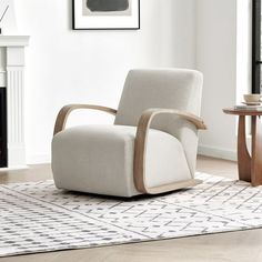 a living room with a white chair and fireplace