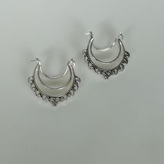 Indian style sterling silver ethnic hoops. Dimensions: 19 x 24 mm Price listed is for ONE PAIR. These earrings are made of 925 hypoallergenic sterling silver. Please note this price is for ONE PAIR only. All my pieces are sent in a gift box. I can include a personal message from you if needed You are welcome to contact me at... bhavnakwintra1956@gmail.com For more beautiful pieces from my shop, please browse 👇 TOE RINGS: https://www.etsy.com/your/shops/TheSilverGame/tools/listings/section:27020 Silver Hoop Earrings With Ear Wire, Silver Hoop Chandelier Earrings, Handmade Silver Hoop Chandelier Earrings, Silver Bohemian Hoop Earrings For Festivals, Silver Crescent Hoop Earrings With Ear Wire, Bohemian Small Hoop Silver Earrings, Silver Crescent Plug Earrings For Pierced Ears, Festive Bohemian Silver Hoop Earrings, Silver Bohemian Small Hoop Earrings