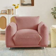 a living room with a pink chair in it