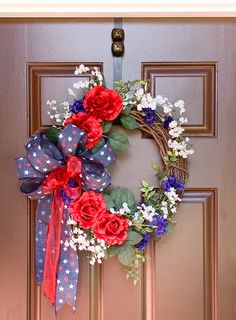 a patriotic wreath with red, white and blue flowers