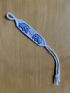 a blue beaded object on a wooden surface