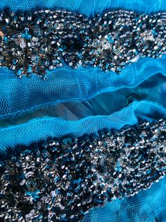 This gorgeous applique makes the perfect start to a black tie gown or Greek Goddess dress! Beautiful silver beads are hand sewn onto a turquoise lace mesh. Sold by the piece. Blue Beaded Fitted Sequin Fabric, Blue Beaded Sequin Fabric, Fitted Blue Beaded Sequin Fabric, Embellished Blue Sequin Fabric For Prom, Blue Embellished Sequin Fabric For Prom, Glamorous Blue Embellished Sequin Fabric, Elegant Blue Beaded Sequin Fabric, Blue Beaded Lace Sequin Fabric, Greek Goddess Dress