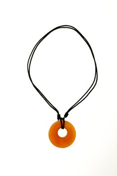 A polished open circle of fiery orange carnelian stone hangs from black knotted cord for an adjustable necklace that's as versatile as it is striking. Each pendant perfection was handcrafted by at-risk and rescued artisans in Thailand, and your purchase contributes to their safe, sustainable means of income. Circle Stone Necklace, Orange Accessories, Dr Wardrobe, Streamer Dr, Orange Carnelian, Orange Necklace, Carnelian Pendant, Carnelian Stone, Small Details