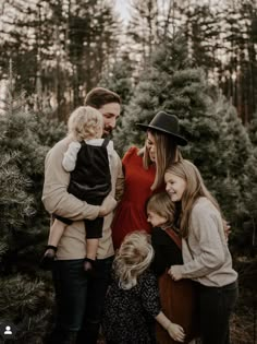 a family standing in front of a christmas tree