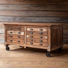 an old wooden dresser with metal knobs on wheels