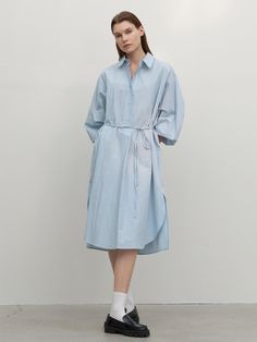 This long shirt dress from Atelier Nain features a wide placket and a half-open design, offering comfort without the gap between buttons.- With a belt to accentuate the waistline- Oversized fit for comfortable wear experience- The uneven hemline to add a unique point of interest* Model shots may differ from the actual product color due to shooting location, time, and graphic techniques. Refer to the product cut images for the actual color. Spring Shirt Dress With Tie Waist And Relaxed Fit, Spring Relaxed Fit Shirt Dress With Tie Waist, Relaxed Fit Belted Shirt Dress For Spring, Knee-length Shirt Dress With Belted Cuffs For Daywear, Spring Relaxed Fit Belted Shirt Dress, Spring Midi Shirt Dress With Roll-up Sleeves, Relaxed Fit Shirt Dress With Tie Waist For Daywear, Casual Spring Shirt Dress With Belted Cuffs, Relaxed Fit Belted Midi Dress For Daywear