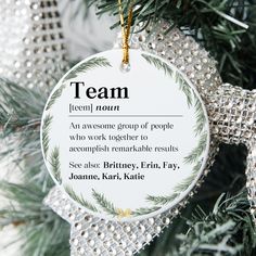 an ornament hanging from a christmas tree with the words team on it's side