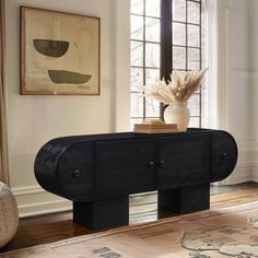 a living room with a black console table