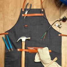 an apron and tools are laid out on the floor