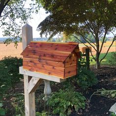 a wooden bird house sitting on top of a tree