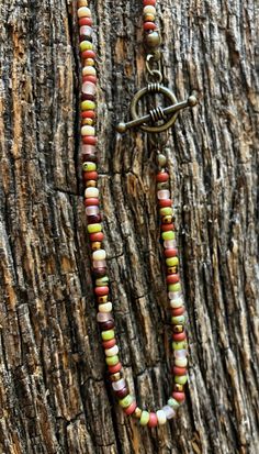 Clay red, pink, tan, and green seed beads.  16 inches in length. It closes with an antique brass toggle clapse. Bestie Gift Ideas, Girl Necklace, Colorful Necklace, Pretty Necklace, Bestie Gifts, For Her Gifts, Pretty Necklaces, Bohemian Necklace, Seed Bead Necklace