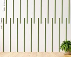 a potted plant sitting on top of a wooden floor next to a white wall