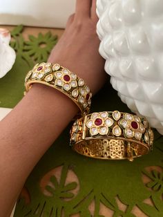 Timeless Beauty. Add glamour and charm to your occasion wear with these Royal Kundan Bangles. Easily Openable with a screw Available in sizes 2.4 ( Inner Diameter 2.25 inches ) Set of Two Material: Brass, Kundan Stones, and gold plated. Adjustable Temple Jewelry Bangle For Wedding, Wedding Bangle Openable, Elegant Cutdana Bracelets For Wedding, Elegant Cutdana Bangle For Wedding, Elegant Wedding Bangle With Cutdana, Elegant Kundan Bangle For Marriage, Elegant Meenakari Bracelets For Party, Adjustable Bangle For Wedding And Festive Occasions, Elegant Bangle For Wedding And Festive Occasions