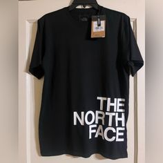 New Black North Face Short Sleeve Shirt. 100% Cotton Size Small. Standard Fit. The North Face On The Front With The Emblem On The Back. The North Face Relaxed Fit Top For Streetwear, The North Face Cotton Graphic Tee, The North Face Crew Neck Top With Letter Print, The North Face Letter Print Streetwear Tops, The North Face Black Crew Neck T-shirt, Black The North Face Crew Neck T-shirt, The North Face Graphic Print Tops For Streetwear, Black Crew Neck T-shirt By The North Face, The North Face Black Casual T-shirt