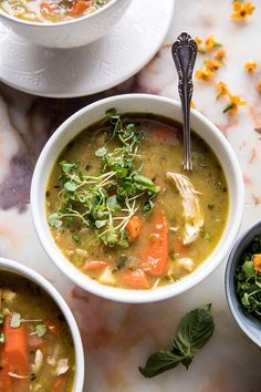 three bowls filled with soup on top of a table