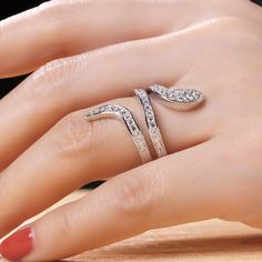 The snake is one of the oldest and most widespread mythological symbols, a symbol of transformation, rebirth and immortality. Crafted in sterling silver, the ring is set with glittering white stones as skin and decorated with smaller stones to add its spark. If you are interested in snake jewelry, just add this ring to your jewelrybox.Carat Weight: 1.471 ctStone Size: 1.9,1.7,1.5,1.3 mmStone Type: Jeulia® StoneNumber of Stones: 42 Stone Color: Diamond WhiteStone Shape: RoundWeight: 6 gWidth: 2.6 Elegant Snake-shaped Jewelry With Diamond Accents, Snake-shaped Diamond Jewelry For Anniversary, Diamond Snake Shape Jewelry For Anniversary, Snake Shape Diamond Jewelry For Anniversary, Elegant Snake-shaped Diamond Ring, White Gold Diamond Snake Ring, Fine Jewelry, Diamond Snake Ring Fine Jewelry, Luxury Silver Snake Ring, White Gold Fine Jewelry Snake Ring