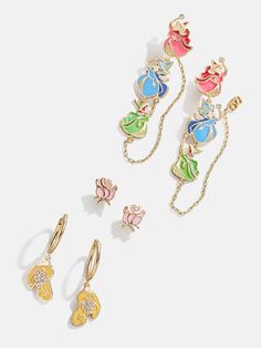 three pairs of disney princess earring and necklaces on a white background with the same color