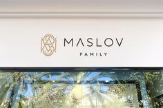 the logo for maslov family is reflected in the window