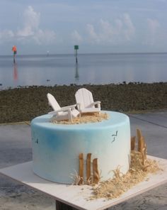 there is a cake that looks like a beach chair on top of the sand and grass