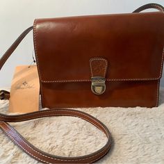 Patricia Nash Nwt Brown Leather Crossbody Bag * Beautiful Classic Brown/ Tan Color * Very Versatile With A Center Zip Pocket Creating 2 Sides Sections. * One Section Has An Interior Zip Pocket And The Other Has 8 Wallet Slots * A Third Interior Section Is Perfect For A Phone Or Glasses * Exterior Zip Pocket On Back * Interior Lines With Extra Soft Lining * Crossbody Strap 22 Inch Drop *This Is A Crossbody But Has Sooo Many Pockets And Compartments That It Seems Much Larger Due To Great Organization. The Crossbody Strap Unsnaps So This Bag Can Also Be Carried As A Clutch. I Tried To Include All The Details But Please Feel Free To Ask Any Questions. I Want To Be Sure You Love Your New Trea Classic Crossbody Travel Box Bag, Classic Crossbody Box Bag For Travel, Classic Travel Crossbody Box Bag, Formal Pouch Flap Bag With Top Carry Handle, Formal Flap Pouch Bag With Top Carry Handle, Classic Rectangular Satchel With Mobile Phone Bag, Classic Rectangular Satchel With Phone Bag, Classic Pouch Shoulder Bag With Mobile Phone Holder, Classic Shoulder Bag With Mobile Phone Pouch