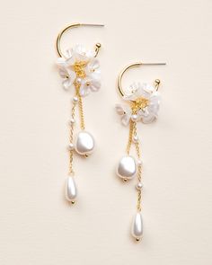 "MORENA DANGLE EARRINGS  Our Morena Dangle Earrings are designed to be one-of-a-kind floral dangle hoops that will have everyone asking \"where did you get those?!\" Crafted with off white flower clusters & dangling freshwater pearl beads, these earrings are perfect for casual or formal wear. DETAILS * Freshwater pearls, off white flowers, & pearl-like beads * Measures 1\" x 3.25\" length * Hypoallergenic, lead-free & nickel-free * Style #4389 SHOP MORE STYLES https://www.etsy.com/shop/darethcol White Hoop Earrings For Pierced Ears For Celebration, Pearl White Dangle Bridal Earrings, White Drop Earrings For Celebration, White Pearl Drop Jewelry For Marriage, Elegant White Hoop Earrings For Celebration, Elegant White Flower Earrings For Celebration, Dangle Pearl Drop Flower Earrings For Anniversary, Pearl Drop Dangle Flower Earrings For Anniversary, White Pearl Drop Clip-on Earrings For Anniversary