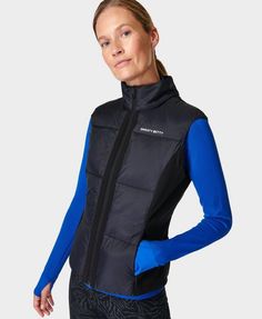 A new-and-improved update on our bestselling running vest . Made from 100% recycled polyamide. Slight funnel neck with more modern, deep shell panelling on the sides. Elasticated cinch detail at the back for a feminine fit. Features a reflective wordmark logo. Front length: 61cm / 24”. Model wears size S and is 178cm/5'10" tall. Style Code: SB8812Colour: Black Fitted Sporty Training Vest, Sporty Fitted Vest For Training, Fitted Vest For Outdoor Activities, Technical Sleeveless Nylon Activewear, Nylon Sports Vest, Sports Nylon Vest, Nylon Sportswear Vest For Sports, Nylon Athleisure Workout Vest, Nylon Athleisure Vest For Workout