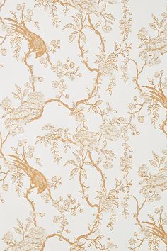 the wallpaper is gold and white with birds on branches, flowers, and leaves