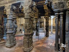 the interior of an old building with sculptures on it's walls and pillars in front of them