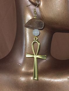 "These earrings are so fire and beautiful. This earrings are  handcrafted with white Quartz with touch a wooden beads. The Ankh means or key of life is an ancient Egyptian hieroglyphic symbol that was most commonly used in writing and in Egyptian art to represent the word for \"life\" and, by extension, as a symbol of life itself. The white Quartz is said to the  stone of master healing. The Egyptian is good combination with Ankh for fashion statement. These crystal are cleanse with salt water b Brown Spiritual Dangle Jewelry, Spiritual White Earrings For Gift, White Spiritual Pierced Jewelry, Handmade Ankh Spiritual Jewelry, Ankh Earrings Jewelry As A Gift, Symbolic Ankh Jewelry For Meditation, Ankh-shaped Earrings For Pierced Ears As Gift, Ankh Jewelry For Pierced Ears As Gift, Ankh Earrings For Pierced Ears Gift