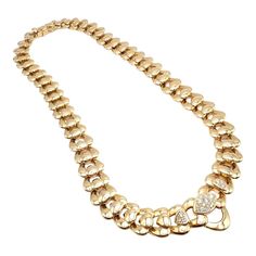 About This Piece: This authentic Marina B statement necklace radiates luxury and style. It's masterfully crafted from 18k yellow gold, featuring a heart-shaped motif that exudes romantic elegance. The center hearts are intricately embellished with... Luxury Refined Necklace With Brilliant Cut, Luxury Classic Jewelry With Hallmarks, Luxury Round Statement Necklace, Luxury Yellow Gold Jewelry With Heart Beads, Diamond Statement Necklace, Necklace Stand, Heart Diamond, Heart Shaped Diamond, Cord Bracelets