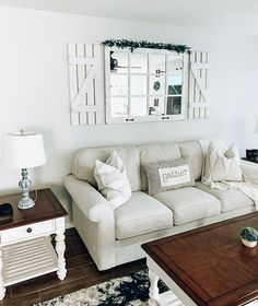 a living room filled with furniture and a mirror