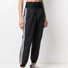 Nwot Adicolor Classics Double-Waisted Fashion Track Pants S From Sport To Hip Hop To High Fashion, The Track Suit Has Come A Long Way. No Wonder It’s Become A Wardrobe Staple. These Adidas Pants Build On That Shiny Waistband. The Recycled Nylon Plain Weave Feels Smooth Against Your Skin. This Product Is Made With Primegreen, A Series Of High-Performance Recycled Materials. Details Regular Fit High-Rise Elastic Waist 100% Recycled Nylon Plain Weave Shiny Waistband Front Pockets Back Pocket Elasti Black High Waist Bottoms With Ribbed Waistband, Black High-waisted Bottoms With Ribbed Waistband, Black High-waist Bottoms With Ribbed Waistband, Black Bottoms With Waistband For Spring, Adidas Athleisure Pants With Elastic Side Panels, Casual Black Bottoms With Banded Waist, Casual Pants With Logo Waistband, Sporty High-waisted Pants, Spring Bottoms With Logo Waistband