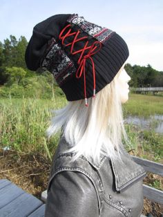 "Cool Hats Bohemian Looks Fair Isle Knit Hat Suede Leather Corset Black White Red Red Faux Leather Corset Tie Accent. Cotton Blend **CHOICE of LACING Color Gray RED Black Medium weight Knit warmer hat. with second knit layer in Fair Isle pattern Measurements: 12\" tall Measurement around Rib 18\" 25.5\" stretched (Medium) Thicker fabric Fair Isles do not stretch too much ) models head size is 22.5\" contents: 60% cotton 40% Acrylic Faux Suede Lace Vacationhouse Hats Many styles and looks. ------ Fitted Black Hats For Cold Weather, Fitted Black Hat For Cold Weather, Casual Beanie For Festivals, Black Outdoor Hat For Fall, Black Casual Hat For Festivals, Black Fall Outdoor Hat, Black Hat For Outdoor Fall Activities, Black Casual Festival Hat, Casual Fall Festival Hats